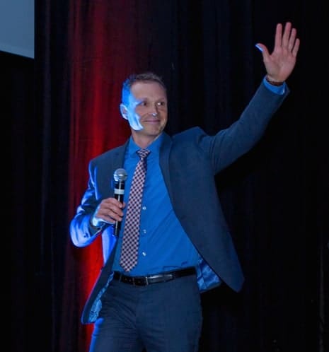 Dale Folland speaking on stage
