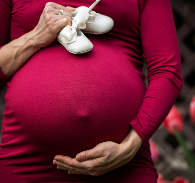 Woman holding baby bump