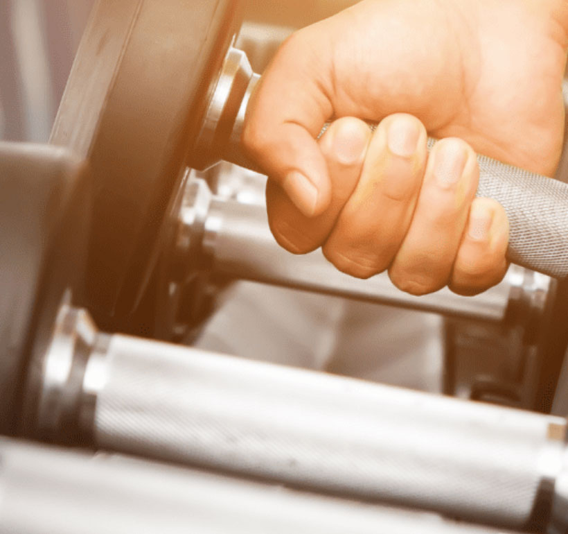 Person picking up dumbbells 